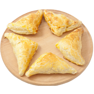 five triangular puff pastries on a wooden plate